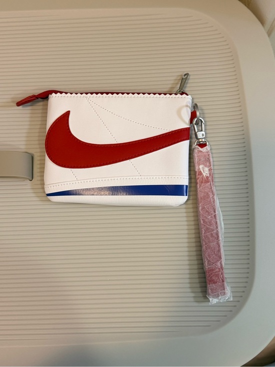 Nike Handbags - Nike White Wristlet Pouch with Red Swoosh and Blue Accent